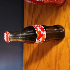 Coca Cola Classic bottle full.  8 FL oz Christmas 1999
